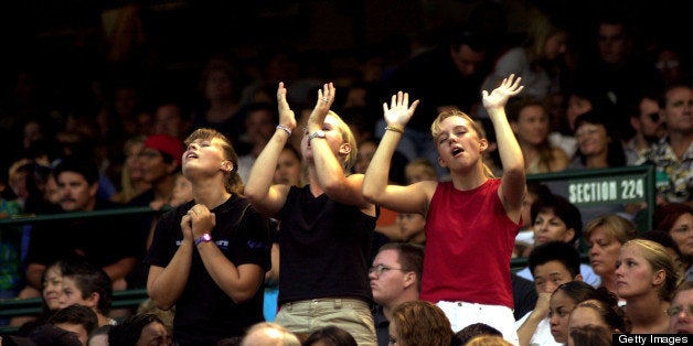 392102 05: Girls praise Jesus as British Christian rock band Delirious performs and evangelizes during a Harvest Crusade gath