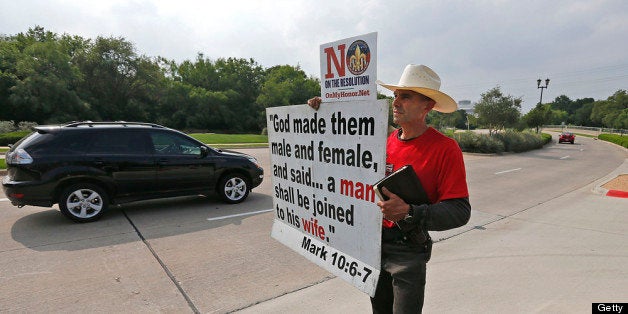 GRAPEVINE, TX - MAY 23: Alan Hoyle, of Lincolnton, North Carolina holds up a sign opposing gays in the Boy Scouts at the Gaylord Texan Resort and Convention Center May 23, 2013 in Grapevine, Texas, The Boy Scouts of America today ended its policy of prohibitting openly gay youths from participating in Scout activities, while leaving intact its ban on gay adults and leaders. (Photo by Stewart F. House/Getty Images)