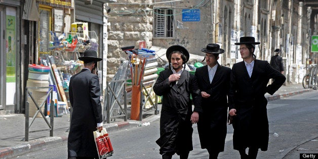 Ultra-Orthodox Jewish men walk around in the Me'a She'arim neighborhood in Jerusalem, Israel, on Sunday, Aug. 1, 2010. Almost 60 percent of Israel's ultra-Orthodox men don't have jobs. The second-fastest-growing population group in the country after the Bedouin, they have prompted Bank of Israel Governor Stanley Fischer and Finance Minister Yuval Steinitz to assert that the haredim, as they are called in Hebrew, may impede Israel's prosperity. Photographer: Ahikam Seri/Bloomberg via Getty Images