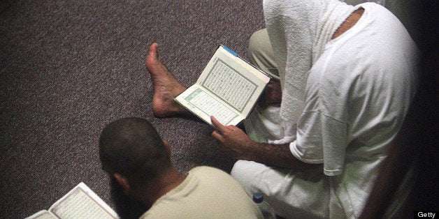 Cooperative detainees in communal detention conduct prayers during Ramadan at the U.S. Navy base at Guantanamo Bay, Cuba on M
