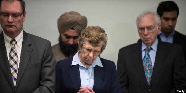 Sister Carol Keehan, president and CEO of the Catholic Health Association of the USA, and others bow their heads for a closing prayer during a press conference at the United Methodist Building January 15, 2013 in Washington, DC. The group of religious leader organized by Faiths United to Prevent Gun Violence held the news conference to speak out against gun violence and call for gun law reform including a ban on assault style weapons and universal background checks. AFP PHOTO/Brendan SMIALOWSKI (Photo credit should read BRENDAN SMIALOWSKI/AFP/Getty Images)