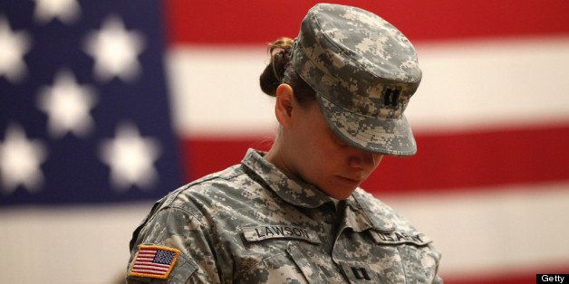 FORT CARSON, CO - NOVEMBER 10: A U.S. Army soldier bows her head in prayer at a welcome home ceremony for troops returning from Iraq on November 10, 2011 in Fort Carson, Colorado. More than 100 soldiers from the 549th Quartermaster Company, 43rd Sustainment Brigade returned after a seven-month deployment. They played a key role in removing excess equipment from Iraq as other troops withdrew from the region. (Photo by John Moore/Getty Images)