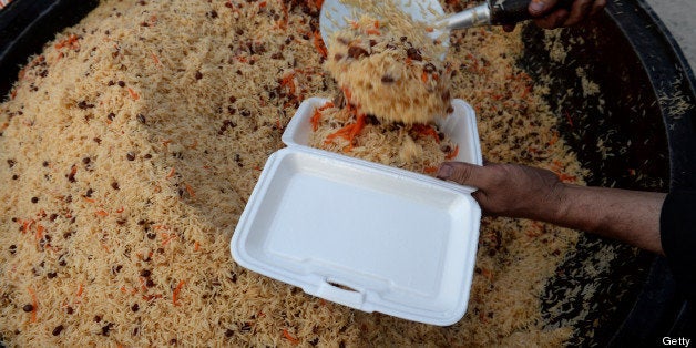 An Afghan Muslim prepares the free evening meal during Iftar at the Eidga mosque in Kabul on July 10, 2013, during the Islami