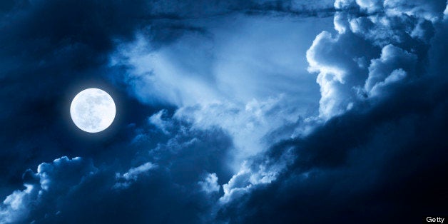 This dramatic photo illustration of a nighttime scene with brightly lit clouds and large, full, Blue Moon would make a great background for many uses.