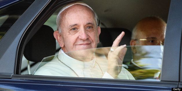 Pope Francis waves to faithfull as he arrives for his first Angelus at his summer residence in Castelgandolfo, 40 kms south east of Rome on July 15, 2013. AFP PHOTO / ANDREAS SOLARO (Photo credit should read ANDREAS SOLARO/AFP/Getty Images)