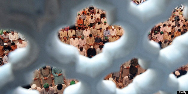 Pakistani Muslims offer Friday prayers at mosque during the month of Ramadan in Lahore on July 19, 2013. Islam's holy month o