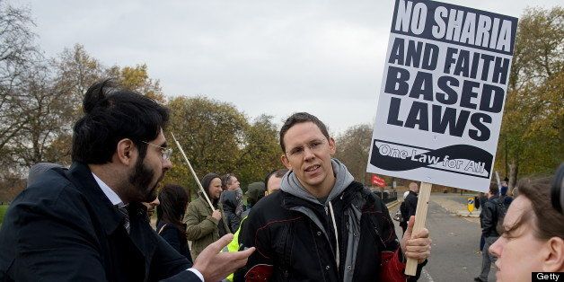 A Sharia Law supporter (L) argues with a demonstrator at an anti-Sharia law demonstration in Hyde Park, central London on November 21, 2009. The organisers were calling for an end to all religion-based courts to be abolished due to their alleged discrimination against women and children. AFP PHOTO/Leon Neal (Photo credit should read LEON NEAL/AFP/Getty Images)