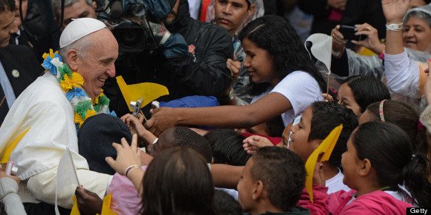 Pope Francis is surrounded by children as he strolls around during his visit to the Varginha favela in Rio de Janeiro, on July 25, 2013. The Varginha favela is a community of 1,000 people which for decades was under the sway of narco-traffickers until it came under police control less than a year ago. The first Latin American and Jesuit pontiff arrived in Brazil mainly for the huge five-day Catholic gathering World Youth Day. AFP PHOTO / YASUYOSHI CHIBA (Photo credit should read YASUYOSHI CHIBA/AFP/Getty Images)