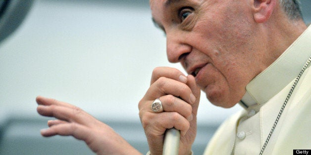 Pope Francis speaks during a long press conference held aboard the papal flight on their way back to Italy upon departure from Rio de Janeiro in Brazil, on July 28, 2013. Pope Francis returned to Rome late Sunday after leading a giant beach mass in Brazil for three million pilgrims, ending his historic trip to reignite Catholic passion with pleas for a humbler Church. AFP PHOTO/LUCA ZENNARO/POOL (Photo credit should read LUCA ZENNARO/AFP/Getty Images)