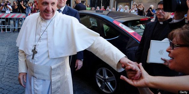 Pope Francis his greeted by a faithful as arrives at the Chiesa Del Gesu' in Rome on July 31, 2013. The Pontiff celebrates a mass for St. Ignatius of Loyola, founder of the Society of Jesuits. AFP PHOTO / ALBERTO PIZZOLI (Photo credit should read ALBERTO PIZZOLI/AFP/Getty Images)