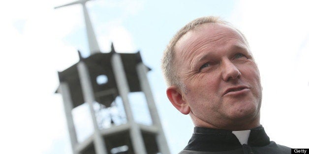 Polish priest Wojciech Lemanski meets with his parishoners in Jasienica near Warsaw, Poland, on July 14, 2013. Father Wojciech Lemanski of the parish of Jasienica has officially been given early retirement by his archbishop Henryk Hoser for 'disobedience to bishops' and for his statements on bioethics which go against the churchs official line. AFP PHOTO / PAP / LESZEK SZYMANSKI POLAND OUT EASTNEWS OUT (Photo credit should read Leszek Szymanski/AFP/Getty Images)