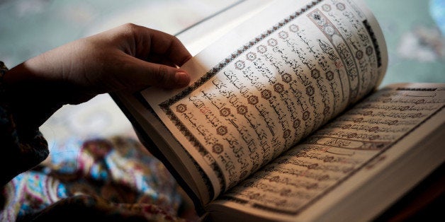 A young Bahraini Shiite Muslim girl reads the Koran, Islam's holy book, during the holy fasting month of Ramadan at a mosque