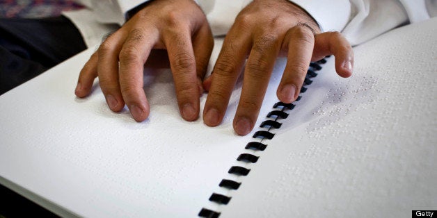 YOGYAKARTA, INDONESIA - AUGUST 02: A blind men reads Braille Quran at Disability Rehabilitation Centers during holy month of Ramadan on August 2, 2013 in Yogyakarta, Indonesia. The centre cares for around 30 Muslim patients who suffer from blindness and on each day of Ramadan they read a braille version of the Qur'an together. The Disability Rehabilitation Center Yogyakarta is a center of services and rehabilitation, aimed at improving the lives of people with disabilities. (Photo by Ulet Ifansasti/Getty Images)