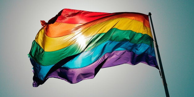 Rainbow flag flies against blue sky in the Castro.