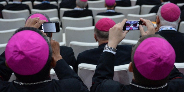 Bishops take pictures of Pope Francis with mobile phones at the Archbishop's Palace in Rio de Janeiro, Brazil on July 27, 2013. Pope Francis urged the Brazilian Roman Catholic Church on Saturday to win back believers who abandoned it for other religions or lost faith. AFP PHOTO / POOL - LUCA ZENNARO (Photo credit should read LUCA ZENNARO/AFP/Getty Images)