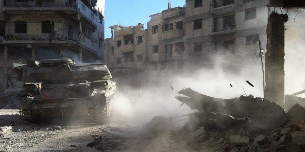 A Syrian government forces' tank rolls in the Khaldiyeh district of Syria's central city of Homs on July 28, 2013. The Syrian government announced on July 29, the capture of Khaldiyeh, a key rebel district in Homs, Syria's third city and a symbol of the revolt against President Bashar al-Assad. AFP PHOTO/STR (Photo credit should read STR/AFP/Getty Images)