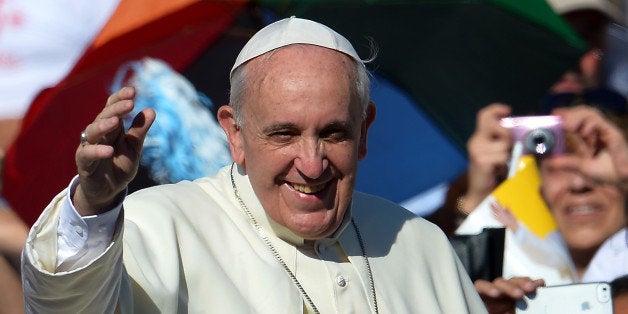 Pope Francis salutes as he arrives for his weekly open-air general audience on September 4, 2013 in St.Peters square at the V