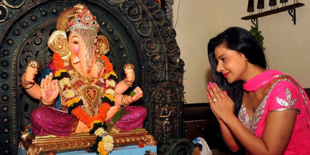 Indian Bollywood film actress Sambhavana Seth offers prayers to an idol of Hindu God Lord Ganesh during the festival of 'Ganesh Chaturthi' at her residence in Mumbai on September 9, 2013. AFP PHOTO (Photo credit should read STR/AFP/Getty Images)