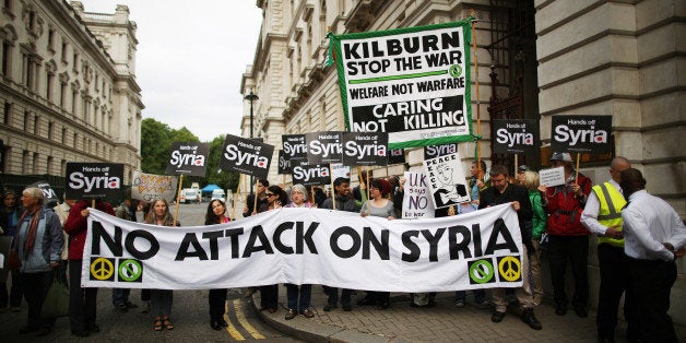 LONDON, ENGLAND - SEPTEMBER 09: Anti-war protestors demonstrate outside The Foreign and Commonwealth Office as US Secretary State John Kerry visits on September 9, 2013 in London, England. UK Foreign Secretary William Hague will be holding talks with US Secretary of State John Kerry today on the crisis in Syria, after Mr Kerry arrived in London last night for a two day visit to London. (Photo by Peter Macdiarmid/Getty Images)