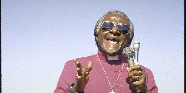 Anti-Apartheid activist Bishop Desmond M. Tutu pleading with crowd to save the life of a suspected police informant whose car was set afire at funeral for 4 black hand grenade victims. (Photo by Selwyn Tait//Time Life Pictures/Getty Images)