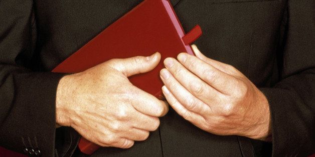 Priest Holding a Bible