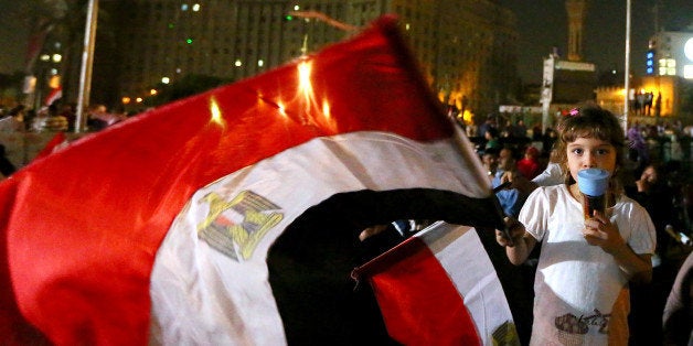 An Egyptian girl waves her country's flag in Cairo's landmark Tahrir square on July 19, 2013, during the 'Tenth of Ramadan' c