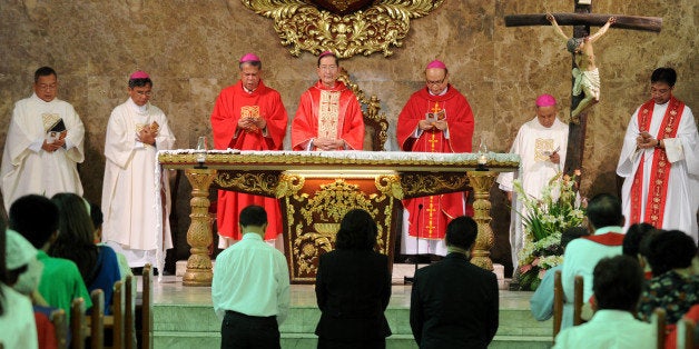 Roman Catholic supporters pray at a mass for lawyers who will be arguing at the Supreme Court against a recently-passed law that requires government to provide contraceptives and sex education in Manila on July 9, 2013. The Catholic church, which counts about 80 percent of Filipinos as followers, has long opposed the law and is challenging it at the Supreme Court. AFP PHOTO / Jay DIRECTO (Photo credit should read JAY DIRECTO/AFP/Getty Images)