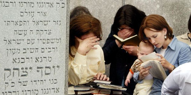 CAMBRIA HEIGHTS, NY - JUNE 22: Hasidic Jewish women pray while visiting the grave of Rabbi Menachem Mendel Schneerson, the seventh grand rebbe of the Lubavitch Hasidic movement, at the Old Montefiore Cemetery June 22, 2004 in Cambria Heights in the Queens borough of New York City. This year is the 10th anniversary of the rebbe's death and thousands of followers from around the world have visited the grave over the past two days. The Lubavitchers consider the mausoleum a holy pilgrimage site. (Photo by Mario Tama/Getty Images)