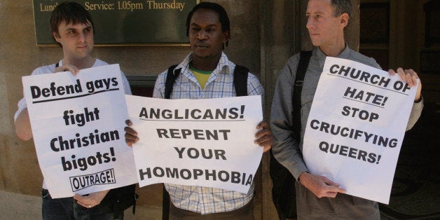 LONDON - JULY 01: Gay right's campaigner Peter Tatchell (R) joined by Kizza Musinguzi (C), a gay rights activist, and Brett Lock, from the group Outrage, protest outside during the Global Anglicanism and English Orthodoxy Local Church Briefing Conference at the All Souls Church on July 1, 2008 in central London, England. Key Anglican figures met at the Global Anglicanism and English Orthodoxy Local Church Briefing Conference to discuss the direction of the Anglican Church. The three archbishops have been involved heavily at the Gafcon (Global Anglican Future) Conference of Anglican traditionalists held in Jerusalem last week and have been at the forefront of introducing the Fellowship of Confessing Anglicans to provide an alternative to the liberal view of homosexuality within the church. (Photo by Daniel Berehulak/Getty Images)