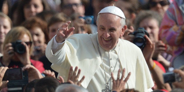 Pope Francis greets the crowd before his general audience at St Peter's square on October 30, 2013 at the Vatican. AFP PHOTO