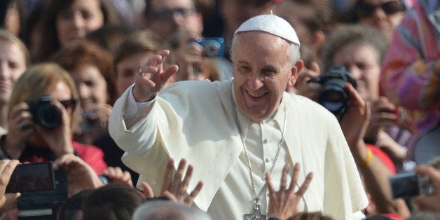 Pope Francis greets the crowd before his general audience at St Peter's square on October 30, 2013 at the Vatican. AFP PHOTO / GABRIEL BOUYS (Photo credit should read GABRIEL BOUYS/AFP/Getty Images)