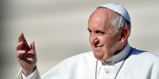 Pope Francis salutes the crowd as he arrives on November 6, 201 3for his general audience in St.-Peter's square at the Vatica