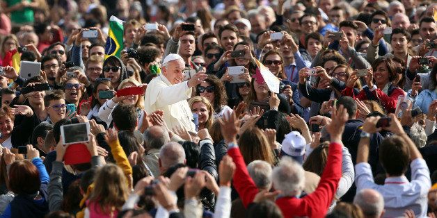 ROME, ITALY - OCTOBER 30: Pope Francis waves to the faithful as he arrives in the popemobile at St. Peter's Square for his weekly audience on October 30, 2013 in Rome, Italy. During the audience the pontiff continued his series of catechetical reflections on the Creed, focusing this week on the Communion of Saints. (Photo by Franco Origlia/Getty Images)