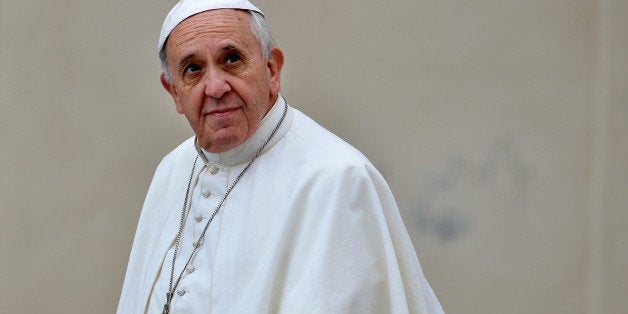 Pope Francis arrives at Saint Peter square to lead his weekly general audience, on November 13, 2013 in the Vatican. AFP PHOTO / ALBERTO PIZZOLI (Photo credit should read ALBERTO PIZZOLI/AFP/Getty Images)