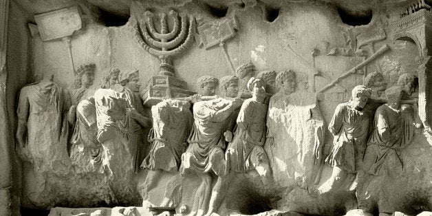 The Roman Forum, Relief from the Arch of Titus showing the triumphal procession after the destruction of Jerusalem in AD 70. Spoils from the Second temple in Jerusalem, including the seven branched candelabra, the silver trumpets and the Table of the Shewbread are carried. Italy. Roman. (Photo by Werner Forman/Universal Images Group/Getty Images)