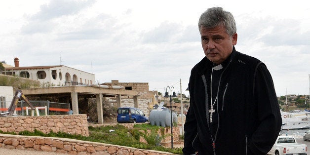 LAMPEDUSA, ITALY - OCTOBER 07: Papal Almoner Archbishop Konrad Krajewski (L) and Bishop of Agrigento Francesco Montenegro arrive at Lampedusa harbour on October 7, 2013 in Lampedusa, Italy. The search for bodies continues off the coast of Southern Italy as the death toll of African migrants who drowned as they tried to reach the island of Lampedusa is expected to reach over 300 people. The tragedy has bought fresh questions over the thousands of asylum seekers that arrive into Europe by boat each year. (Photo by Tullio M. Puglia/Getty Images)