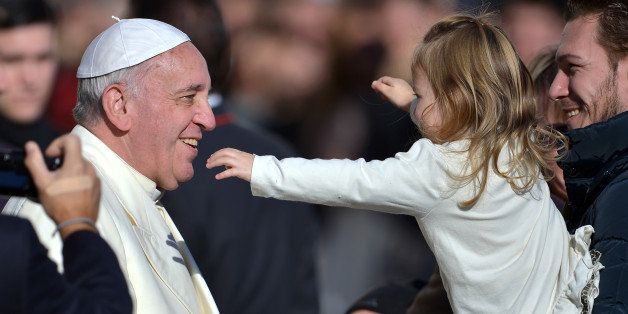 Pope Francis is about to hug a young girl during his general audience in St Peter's square at the Vatican on December 4, 2013. AFP PHOTO / FILIPPO MONTEFORTE (Photo credit should read FILIPPO MONTEFORTE/AFP/Getty Images)