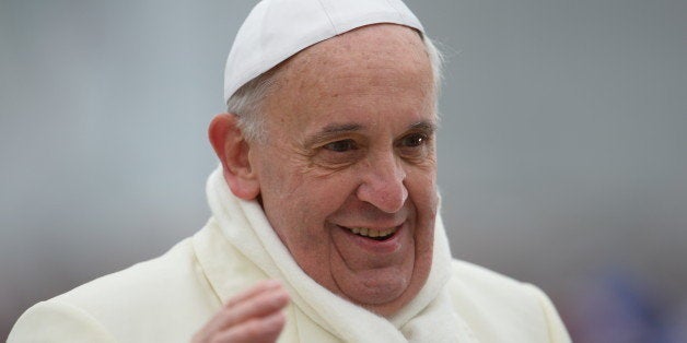 Pope Francis greets the crowd as he arrives for his general audience at St Peter's square on November 27, 2013 at the Vatican. AFP PHOTO / VINCENZO PINTO (Photo credit should read VINCENZO PINTO/AFP/Getty Images)