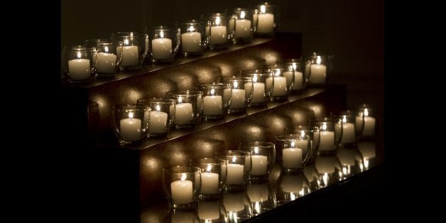 Twenty-six candles sit on a table after being lit by US President Barack Obama and First Lady Michelle Obama, honoring the 26 students and teachers killed at Sandy Hook Elementary School in Newtown, Connecticut, in the Map Rom of the White House in Washington, DC on December 14, 2013. The Obamas also observed a moment of silence on the one-year anniversay of the shooting. AFP PHOTO / Saul LOEB (Photo credit should read SAUL LOEB/AFP/Getty Images)