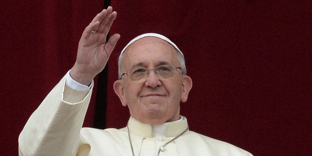 Pope Francis gives his traditional Christmas 'Urbi et Orbi' blessing from the balcony of St. Peter's Basilica on December 25, 2013 at the Vatican. AFP PHOTO / FILIPPO MONTEFORTE (Photo credit should read FILIPPO MONTEFORTE/AFP/Getty Images)