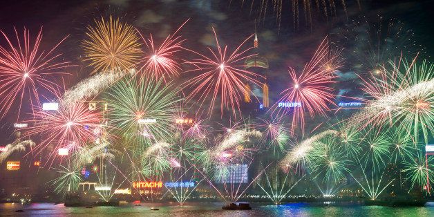 Fireworks explode over Victoria Harbour in Hong Kong on January 1, 2014. A wave of pyrotechnic displays kicked off new year celebrations in major cities around the world, with Hong Kong welcoming 2014 with a choreographed music and fireworks show. AFP PHOTO / ALEX OGLE (Photo credit should read Alex Ogle/AFP/Getty Images)