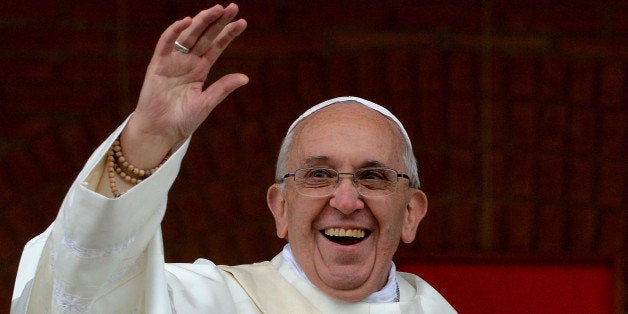 Pope Francis waves to the crowd gathering outside the Basilica of Our Lady of Aparecida, Brazil's most revered Catholic shrine, after he celebrated mass there, in Aparecida, Sao Paulo State, on July 24, 2013. Pope Francis warned Catholics on Wednesday against 'ephemeral idols' like money at his first public mass in his native Latin America as huge crowds lined the streets to cheer him. The first Latin American and Jesuit pontiff visited Aparecida to lead his first big mass since arriving in the country for a week-long visit of which highlight is the huge five-day Catholic gathering World Youth Day. AFP PHOTO/LUCA ZENNARO/POOL (Photo credit should read LUCA ZENNARO/AFP/Getty Images)