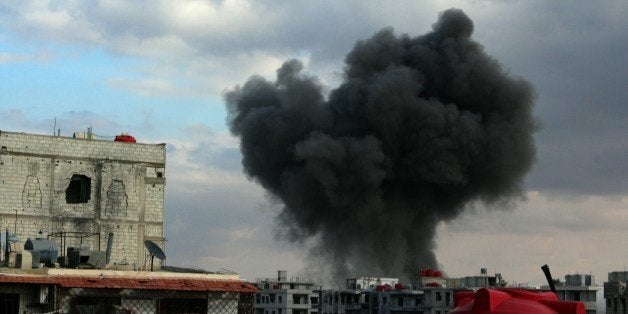 A picture taken on January 13 2014, shows smoke billowing from buildings in the city of Daraya, southwest of the capital Damascus, as fighting between opposition forces and troops loyal to the government of Syrian President Bashar al-Assad continues. Syria's civil war has killed more than 130,000 people, and forced millions more to flee their homes. AFP PHOTO/HUSSAM AYASH/LOCAL COUNCIL OF DARAYA CITY (LCDC) (Photo credit should read HUSSAM AYASH/AFP/Getty Images)