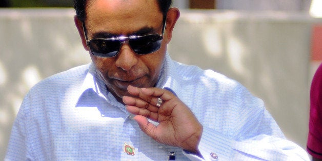 In this photograph taken on November 16, 2013, Maldivian presidential candidate Abdulla Yameen blows on his finger marked wit