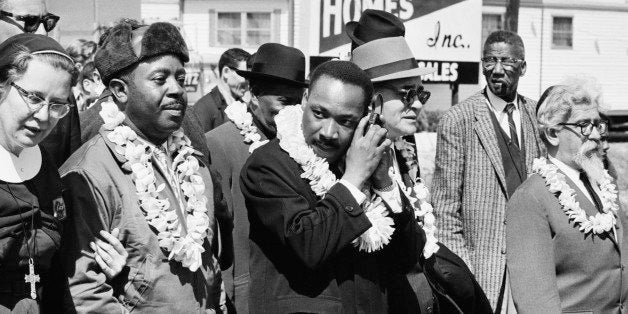 African-American civil rights activist Martin Luther King, Jr. (1929 - 1968, centre) listening to a transistor radio in the front line of the third march from Selma to Montgomery, Alabama, to campaign for proper registration of black voters, 23rd March 1965. Among the other marchers are: Ralph Abernathy (1926 - 1990, second from left), Ralph Bunche (1903 - 1971, third from right) and Rabbi Abraham Joshua Heschel (1907 - 1972, far right). The first march ended in violence when marchers were attacked by police. The second was aborted after a legal injunction was issued. (Photo by William Lovelace/Daily Express/Hulton Archive/Getty Images)