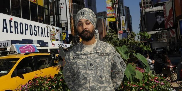 TO USE WITH AFP STORY by Shaun Tandon, US-MILITARY-RELIGION-SIKHS US Army Captain Kamaljeet Singh Kalsi poses in Times Square, New York, on September 14, 2010 , wearing his US Army ACU Digital Camouflage turban along with his ACU uniform. Kalsi, who is the first Sikh in the US Army, is an emergency room doctor and emergency medical services (EMS) Director stationed at Ft. Bragg. In what appears to be a quiet shift, the US military since last year has allowed Sikhs to serve while retaining their turbans and beards, which are required by their faith. AFP PHOTO / TIMOTHY A. CLARY (Photo credit should read TIMOTHY A. CLARY/AFP/Getty Images)