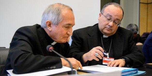 Vatican's UN Ambassador Monsignor Silvano Tomasi (L) speaks with Former Vatican Chief Prosecutor of Clerical Sexual Abuse Charles Scicluna prior to the start of a questioning over clerical sexual abuse of children at the headquarters of the United Nations (UN) High Commissioner for Human Rights, on January 16, 2014 in Geneva. The UN's top child rights watchdog Thursday urged the Catholic Church put its house in order over sexual abuse of children, as the Vatican defended its record in the face of continued scandals. Like other signatories of the 1989 UN Convention on the Rights of the Child, the Holy See agrees to submit regular reports on respect for the rules, and to be scrutinised by the watchdog panel. Thursday marked the Vatican's second examination. AFP PHOTO / FABRICE COFFRINI (Photo credit should read FABRICE COFFRINI/AFP/Getty Images)