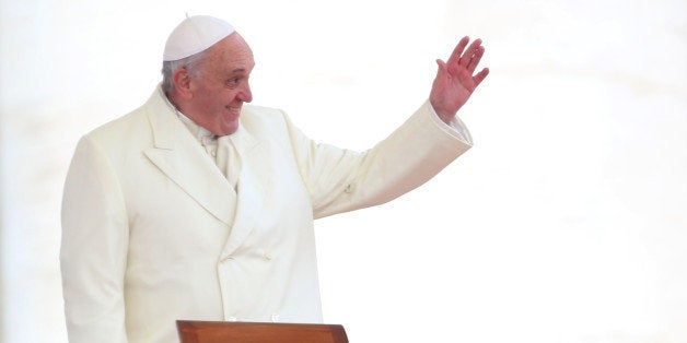 VATICAN CITY, VATICAN - JANUARY 29: Pope Francis waves to the faithful as he holds his weekly audience in St. Peter's Square on January 29, 2014 in Vatican City, Vatican. After his appearance on the cover of Rolling Stone magazine, today Pontiff was also found to be represented in a graffiti in Rome that portrays him in a superhero vest. (Photo by Franco Origlia/Getty Images)