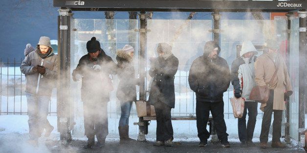 CHICAGO, IL - JANUARY 28: With temperatures hovering around -10 degrees commuters wait for a bus January 28, 2014 in Chicago, Illinois. The city has had 18 days at or below zero so far this winter, two shy of the 20-day record. (Photo by Scott Olson/Getty Images)