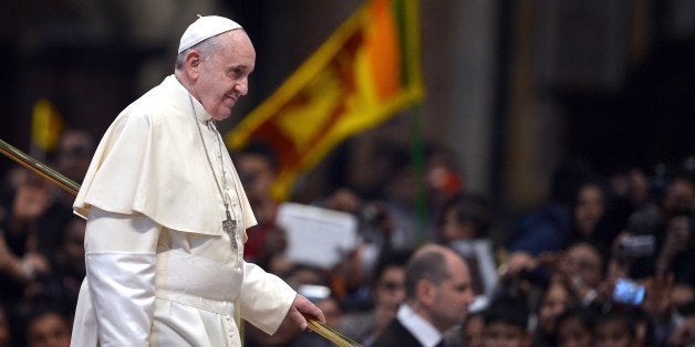 Pope Francis leaves after a meeting with the Sri Lankan community and a mass held by the Archbishop of Colombo at St Peter's Basilica on February 8, 2014 at the Vatican. AFP PHOTO / GABRIEL BOUYS (Photo credit should read GABRIEL BOUYS/AFP/Getty Images)